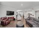 Open concept living area flows into kitchen featuring hardwood floors, modern furniture, and plenty of natural light at 5020 Eldon Dr, Noblesville, IN 46062