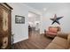 Living room with hardwood flooring and an open view into a bright kitchen at 5020 Eldon Dr, Noblesville, IN 46062
