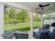 Covered patio with ceiling fan overlooks a large yard with green grass and mature trees at 5020 Eldon Dr, Noblesville, IN 46062