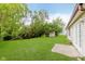 Expansive backyard features a lush lawn, mature trees, and a storage shed at 5083 Emmert Dr, Indianapolis, IN 46221