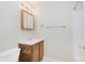 Well-lit bathroom featuring a wood cabinet and a large mirror above the sink at 5083 Emmert Dr, Indianapolis, IN 46221