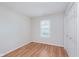 Bright bedroom featuring a window with blinds and hardwood floors for easy maintenance at 5083 Emmert Dr, Indianapolis, IN 46221