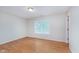 A bright bedroom featuring hardwood floors, a window for natural light, and a closet at 5083 Emmert Dr, Indianapolis, IN 46221