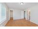 A spacious bedroom with hardwood floors and multiple doors leading to other rooms and closets at 5083 Emmert Dr, Indianapolis, IN 46221