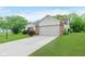 Inviting single-story home featuring a two-car garage, brick accents, and a neatly kept yard at 5083 Emmert Dr, Indianapolis, IN 46221
