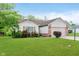 Well-maintained single-story home with a lush green lawn and attached garage at 5083 Emmert Dr, Indianapolis, IN 46221