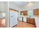 Functional kitchen with white appliances, wooden cabinets, and bright natural lighting at 5083 Emmert Dr, Indianapolis, IN 46221