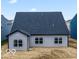 The home features a spacious backyard and exterior with large windows and grey siding at 542 Alder Way, Sheridan, IN 46069