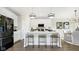 Modern eat-in kitchen features stainless steel appliances, white cabinets, and a breakfast bar at 542 Alder Way, Sheridan, IN 46069