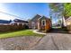 A charming red brick house features a well-kept lawn, patio area, and a private driveway for convenient parking at 5428 E 10Th St, Indianapolis, IN 46219