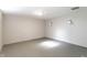 Spacious room with sleek gray flooring and stylish sconce lighting creating a modern aesthetic at 5428 E 10Th St, Indianapolis, IN 46219