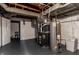 The basement features painted walls and ceiling, and it contains the water heater and furnace for the house at 5428 E 10Th St, Indianapolis, IN 46219