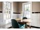 Breakfast nook with natural light, a wooden table and chairs, and white tile with black accents along the walls at 5428 E 10Th St, Indianapolis, IN 46219