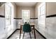 Bright breakfast nook featuring two large windows, a wooden table, and white tile walls with black accents at 5428 E 10Th St, Indianapolis, IN 46219