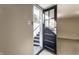 View into the home showcasing a black door with glass panes and an entrance with concrete steps and metal railing at 5428 E 10Th St, Indianapolis, IN 46219