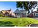 Charming brick home with a cozy front porch and a well-manicured lawn in a residential neighborhood at 5428 E 10Th St, Indianapolis, IN 46219