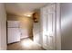 Functional kitchenette space with refrigerator, wooden shelving, and adjacent white door at 5428 E 10Th St, Indianapolis, IN 46219