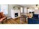 Inviting living room with hardwood floors, fireplace, and open archway at 5428 E 10Th St, Indianapolis, IN 46219