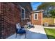 A cozy outdoor patio featuring a quaint table and seating set in a well-manicured backyard at 5428 E 10Th St, Indianapolis, IN 46219