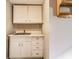 A cozy wet bar with classic white cabinetry and sink providing function with some charm at 5428 E 10Th St, Indianapolis, IN 46219