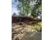 View of backyard featuring a wooden pergola with string lights, deck, and tire swing at 5802 Bertha St, Indianapolis, IN 46241