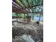 View of backyard featuring a wooden pergola with string lights and tire swing at 5802 Bertha St, Indianapolis, IN 46241