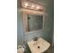 Bathroom vanity with decorative mirror and updated sink at 5802 Bertha St, Indianapolis, IN 46241