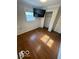 Bedroom featuring hardwood floors, a window, and a closet with shelving at 5802 Bertha St, Indianapolis, IN 46241