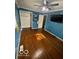 Bedroom with blue walls, hardwood floors, a ceiling fan, a closet, and a TV at 5802 Bertha St, Indianapolis, IN 46241