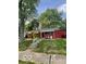 Cozy single-story red home featuring a covered porch and a classic design at 5802 Bertha St, Indianapolis, IN 46241