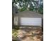 Exterior view of detached garage with white door and siding at 5802 Bertha St, Indianapolis, IN 46241