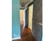 Hallway with hardwood floors and a rustic barn door accent at 5802 Bertha St, Indianapolis, IN 46241