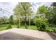 Spacious backyard patio with string lights and mature trees providing a beautiful outdoor space at 5824 W Commonview Dr, McCordsville, IN 46055