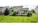 Green backyard featuring a patio with a screened porch area attached to the house at 5824 W Commonview Dr, McCordsville, IN 46055