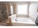 Bright bathroom features a soaking tub with tile surround and a glass-enclosed shower at 5824 W Commonview Dr, McCordsville, IN 46055