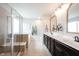 Bathroom featuring a double sink vanity, glass enclosed shower, and a soaking tub at 5824 W Commonview Dr, McCordsville, IN 46055