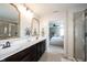 Bathroom featuring a double sink vanity with gold framed mirrors leading to the main bedroom at 5824 W Commonview Dr, McCordsville, IN 46055