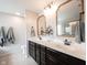 Bathroom featuring a double sink vanity, granite countertop and gold framed mirrors at 5824 W Commonview Dr, McCordsville, IN 46055