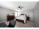Bedroom with a comfortable bed, two nightstands, dresser, carpet, ceiling fan and natural light at 5824 W Commonview Dr, McCordsville, IN 46055