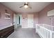 Bedroom with pink walls and door to the hallway at 5824 W Commonview Dr, McCordsville, IN 46055