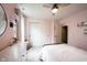 Light-filled bedroom with pink walls, a dresser with a mirror, and sliding door closet at 5824 W Commonview Dr, McCordsville, IN 46055