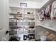 Well-organized closet with shelves, baskets, and hanging clothes at 5824 W Commonview Dr, McCordsville, IN 46055
