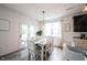 Bright dining area with white table and chairs, French doors, and a view of the backyard at 5824 W Commonview Dr, McCordsville, IN 46055