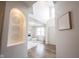 Welcoming entryway featuring hardwood floors, an arched niche with decorative art, and a bright, open floor plan at 5824 W Commonview Dr, McCordsville, IN 46055