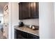 Kitchen nook featuring granite countertops, wood cabinets, and a stylish area to enjoy coffee or prepare snacks at 5824 W Commonview Dr, McCordsville, IN 46055