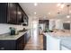 Well-appointed kitchen with dark cabinetry, stainless steel appliances, and granite countertops for modern living at 5824 W Commonview Dr, McCordsville, IN 46055