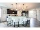 Open kitchen with island seating, granite countertops, dark cabinetry, and stainless steel appliances at 5824 W Commonview Dr, McCordsville, IN 46055