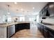 Spacious kitchen with dark cabinets, stainless steel appliances, and a granite countertop, leading into the living area at 5824 W Commonview Dr, McCordsville, IN 46055