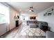 Open-concept living room showcasing a large sectional sofa, a fireplace, and views into the kitchen and dining area at 5824 W Commonview Dr, McCordsville, IN 46055