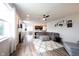 Spacious living room with a large gray sectional, patterned rug, and open view to the kitchen and dining area at 5824 W Commonview Dr, McCordsville, IN 46055